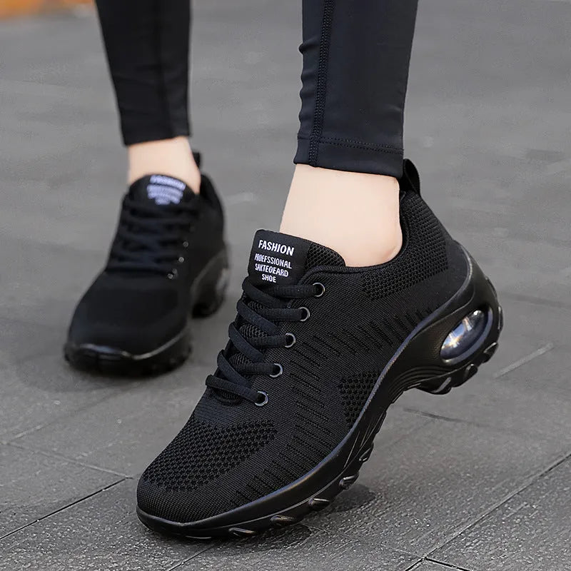 Women's red and black mesh sneakers with lace-up front and round toe design