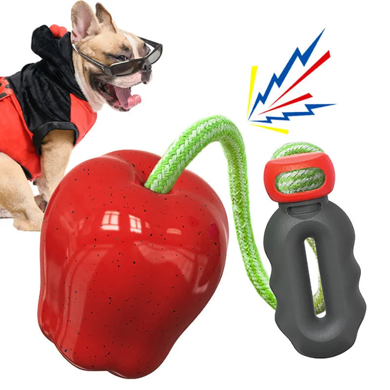 Green plastic dog toy shaped like an apple with a molar texture and a food-dropping ball.