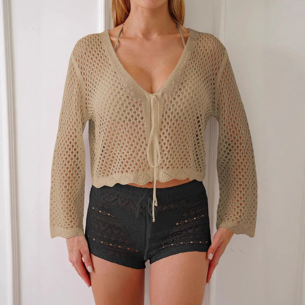 Women's short length cardigan blouse with nine-quarter bell sleeves in a hollow woven imitation cotton fabric.