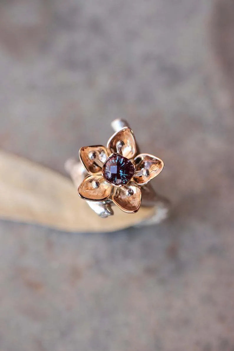 Silver two-tone geometric floral pattern women's alloy ring on a plain background.