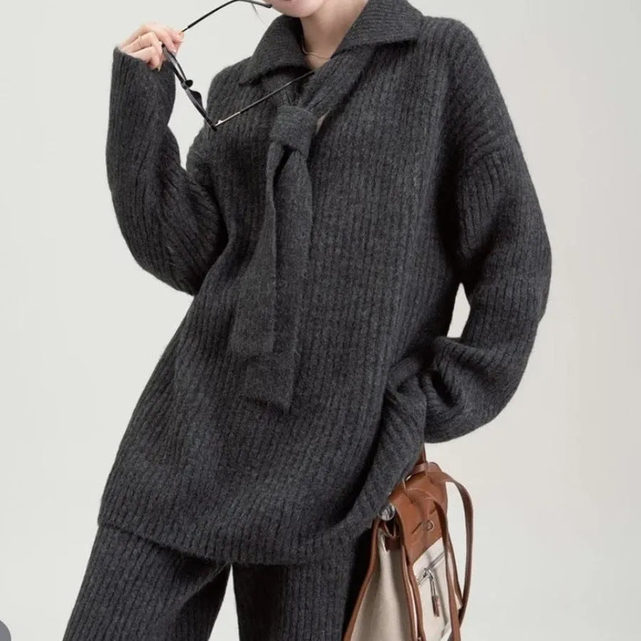 Beige imitation cashmere knitted top and matching trousers two-piece set laid flat.