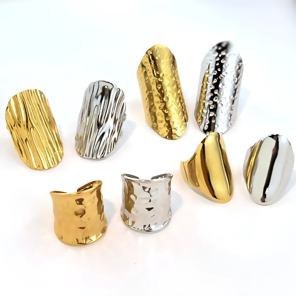 Gold plated geometric open titanium steel ring with striped design on white background