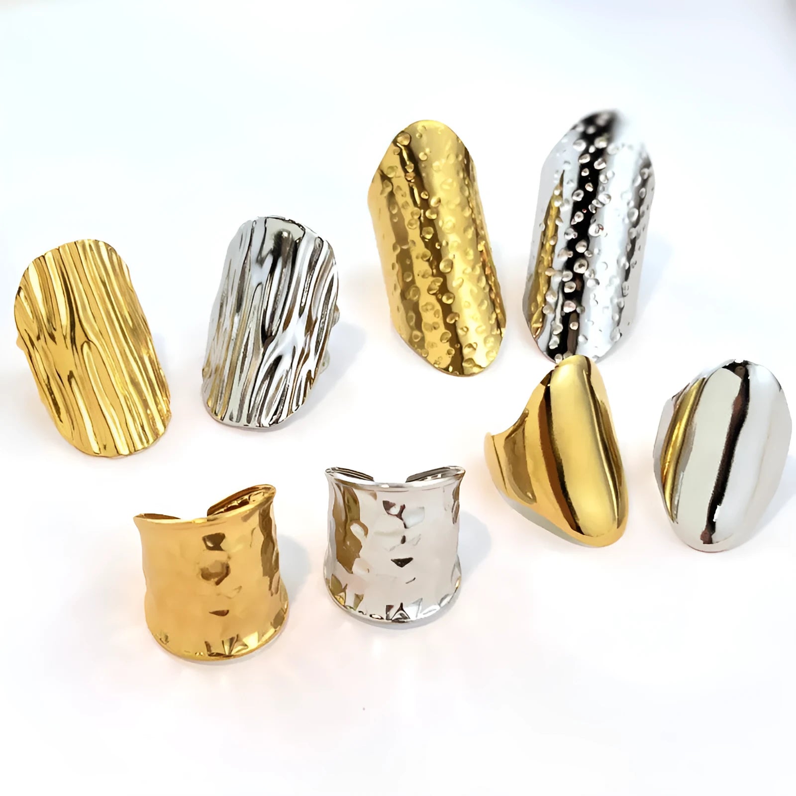 Gold plated geometric open titanium steel ring with striped design on white background