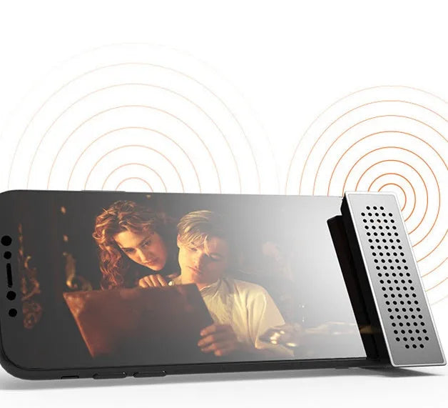 Compact black mobile phone amplifier bracket holding an iPhone on a desktop.