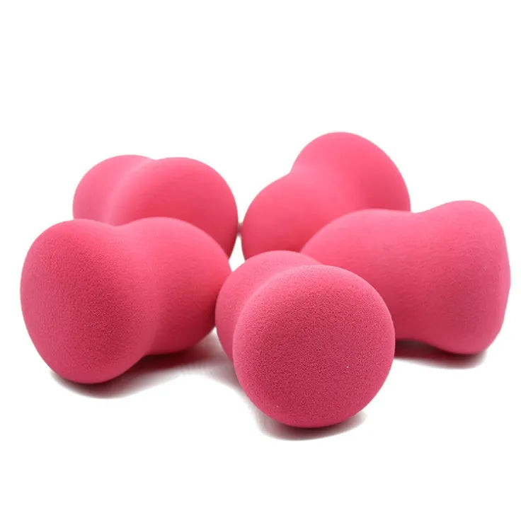 Pink hydrophilic non-latex makeup foundation sponge puff on white background.