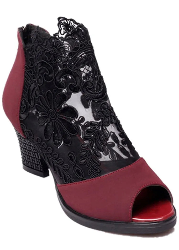 Black lace gladiator sandals for women with a square high heel and peep toe, showing zip closure.