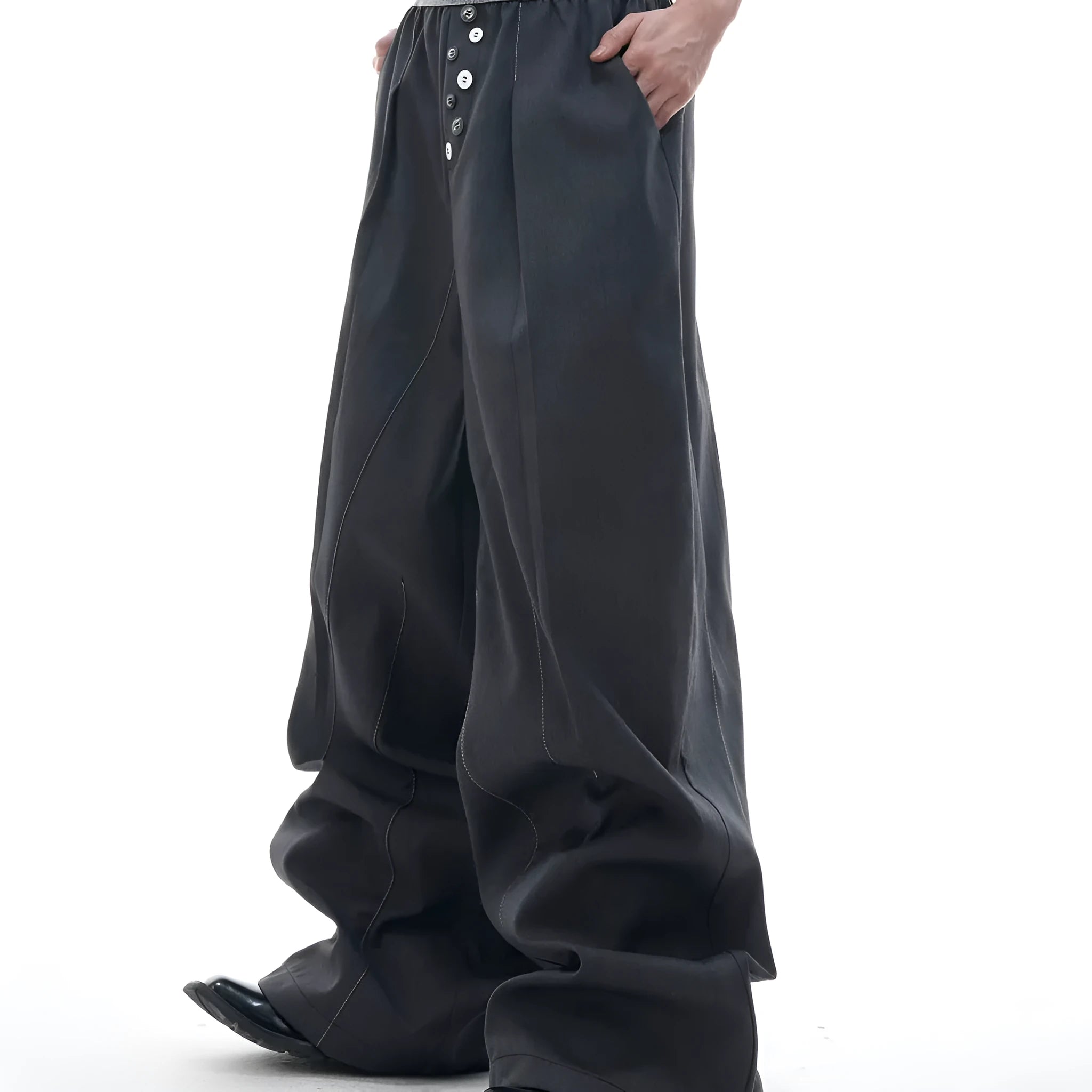 Black straight-leg high-waist trousers with button detail on smart casual model