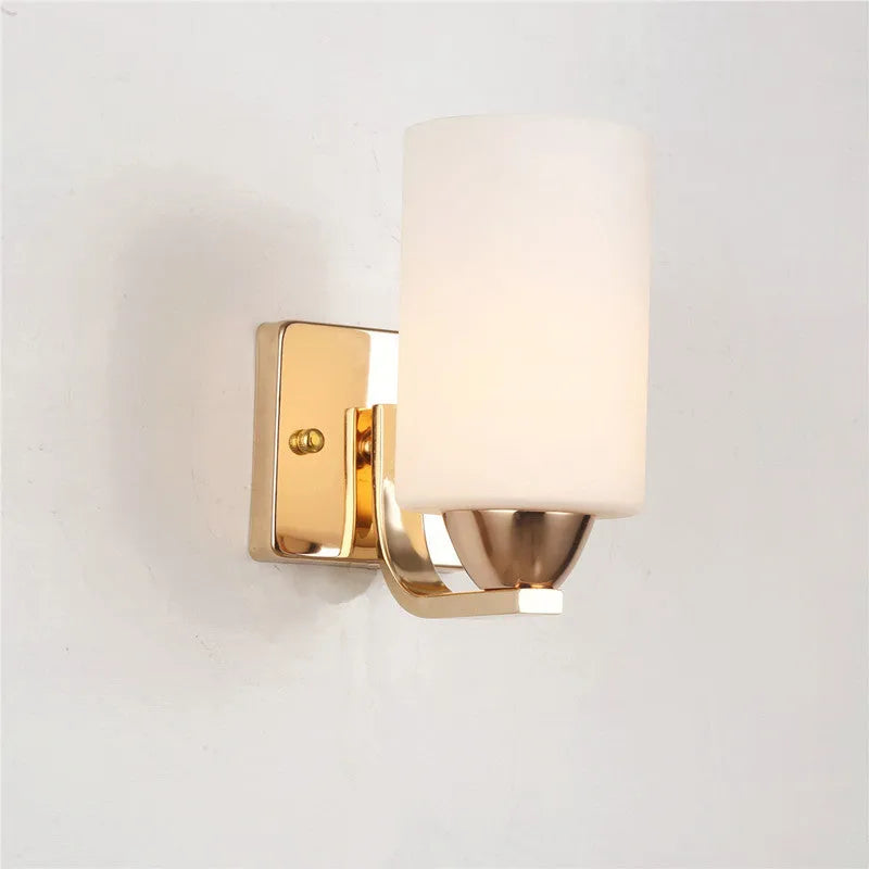 Modern chrome-finished wall lamp with a clear glass shade, shown in a single head configuration.