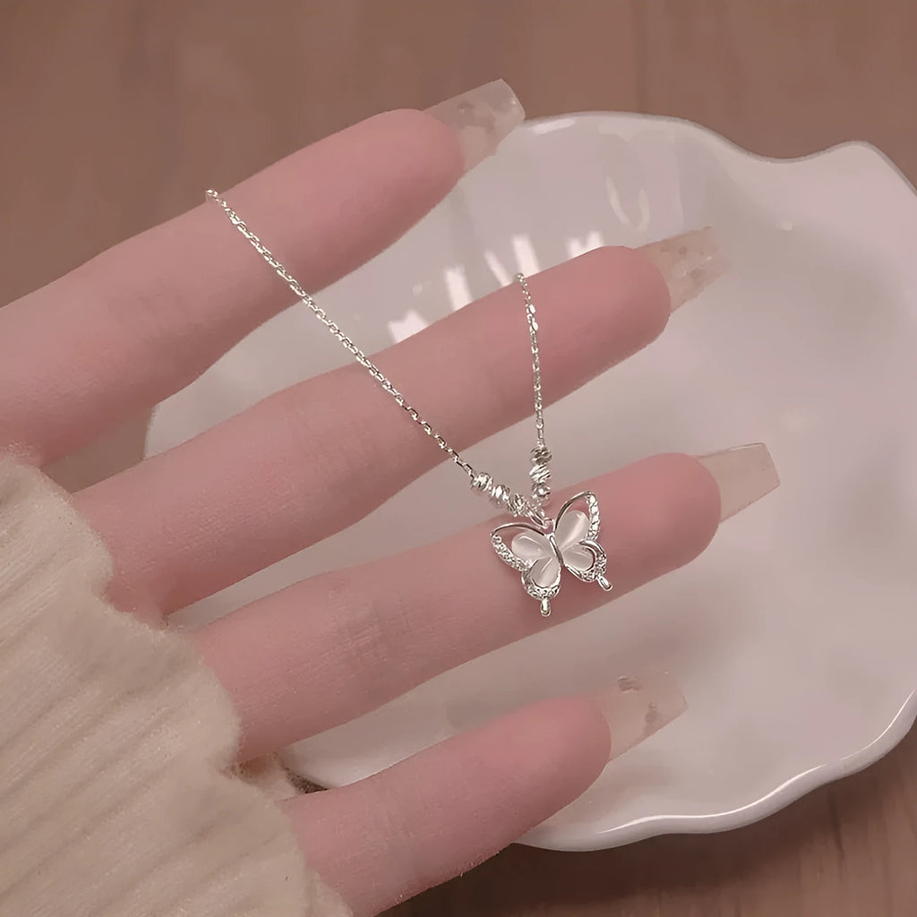 Women's silver butterfly necklace on a cross chain, showing adjustable length and 925 silver pendant.