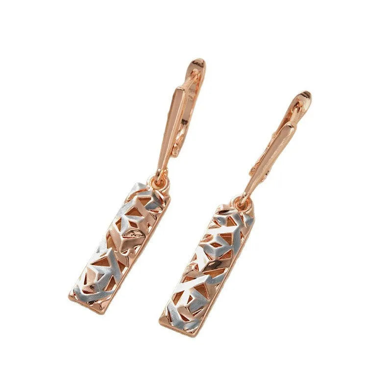A pair of women's rectangular two-tone hollow stud earrings with a geometric design.