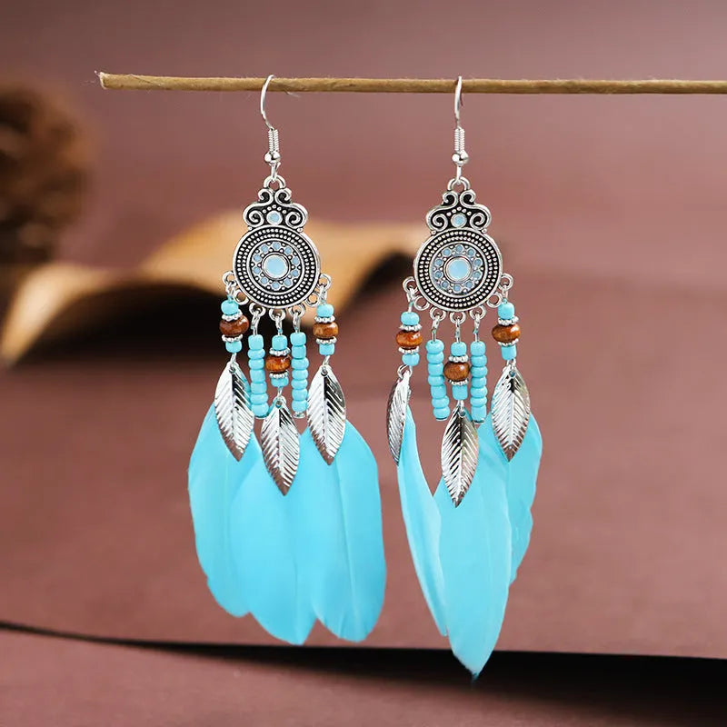 A pair of round drop feather earrings in alloy with Bohemian patterning, shown in one of 14 available colours.
