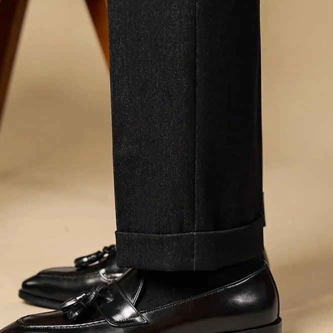 Men's black and brown tassel loafers with polished leather upper and rubber sole in British business casual style