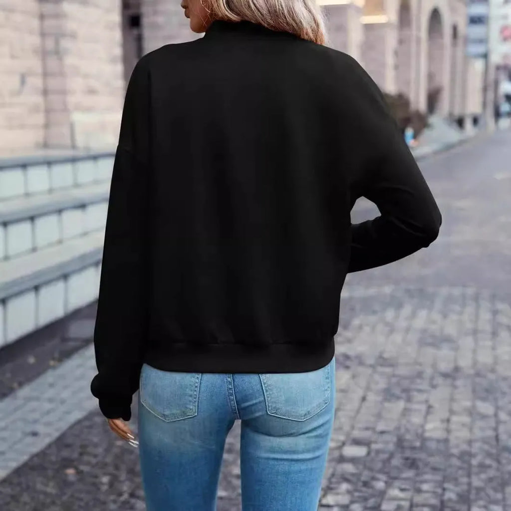 Women's solid black polyester zip jacket with long sleeves and faux pockets