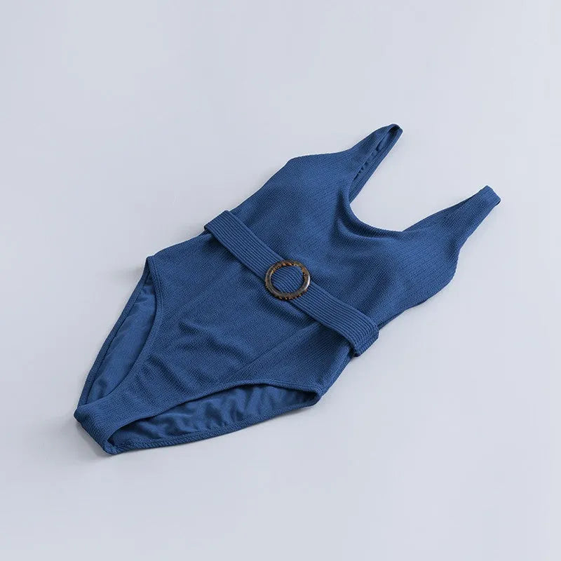 Navy blue women's one-piece swimsuit with slimming triangle silhouette and chest pads for swimming