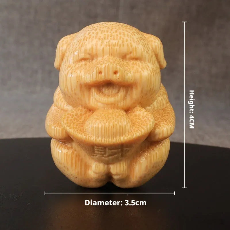 Solid bamboo carving ornament of an ingot pig, 4cm tall, on a wooden surface.