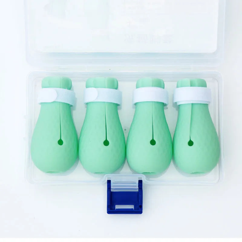 Set of four green silicone cat scratch protection gloves or foot covers.