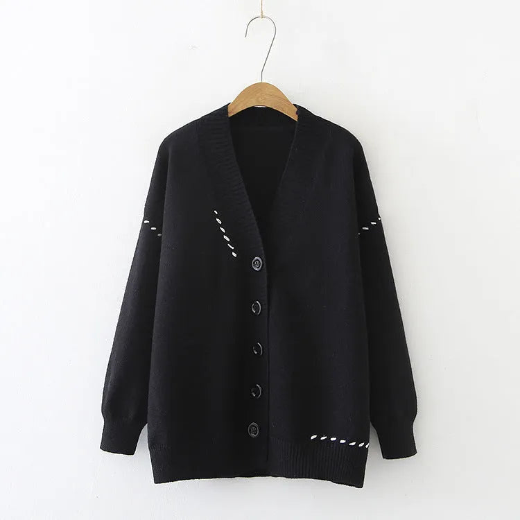 Women's loose fit black knitted cardigan coat with long sleeves.
