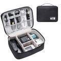 Black waterproof electronics organiser bag open, showing mesh pockets, elastic loops and removable dividers.