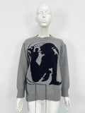 Grey women's loose alpaca wool sweater with a round neck, regular sleeves, and a long tassel detail.
