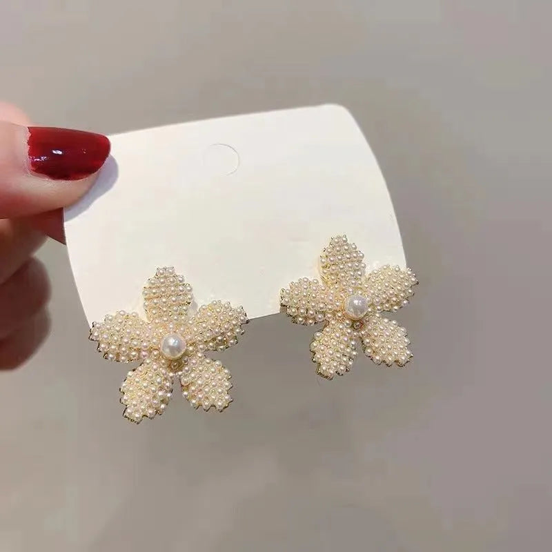 Gold Korean-style alloy earrings with pineapple starfish design and pearl-coloured gem inlays.