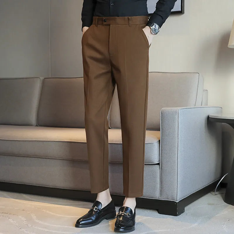 Men's straight leg brown corduroy trousers with an elasticated waistband on a hanger