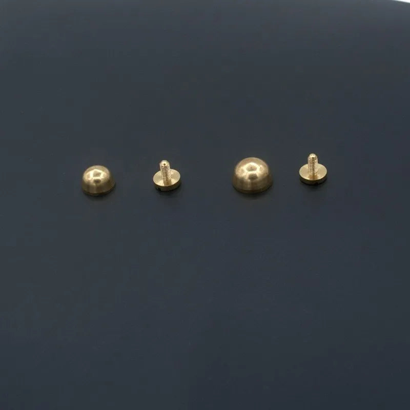 Brass decorative buckle with geometric and round foot nail designs in 10x6mm and 12x7mm sizes.
