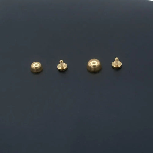 Brass decorative buckle with geometric and round foot nail designs in 10x6mm and 12x7mm sizes.
