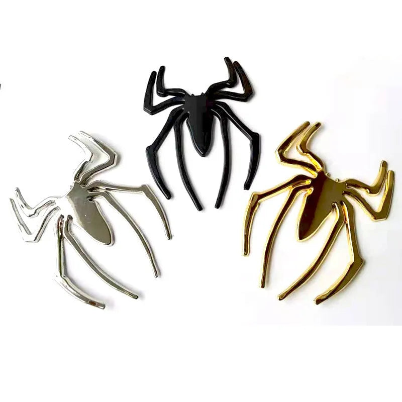 Three-dimensional metal spider sticker in gold colour, measuring 7cm by 5cm.