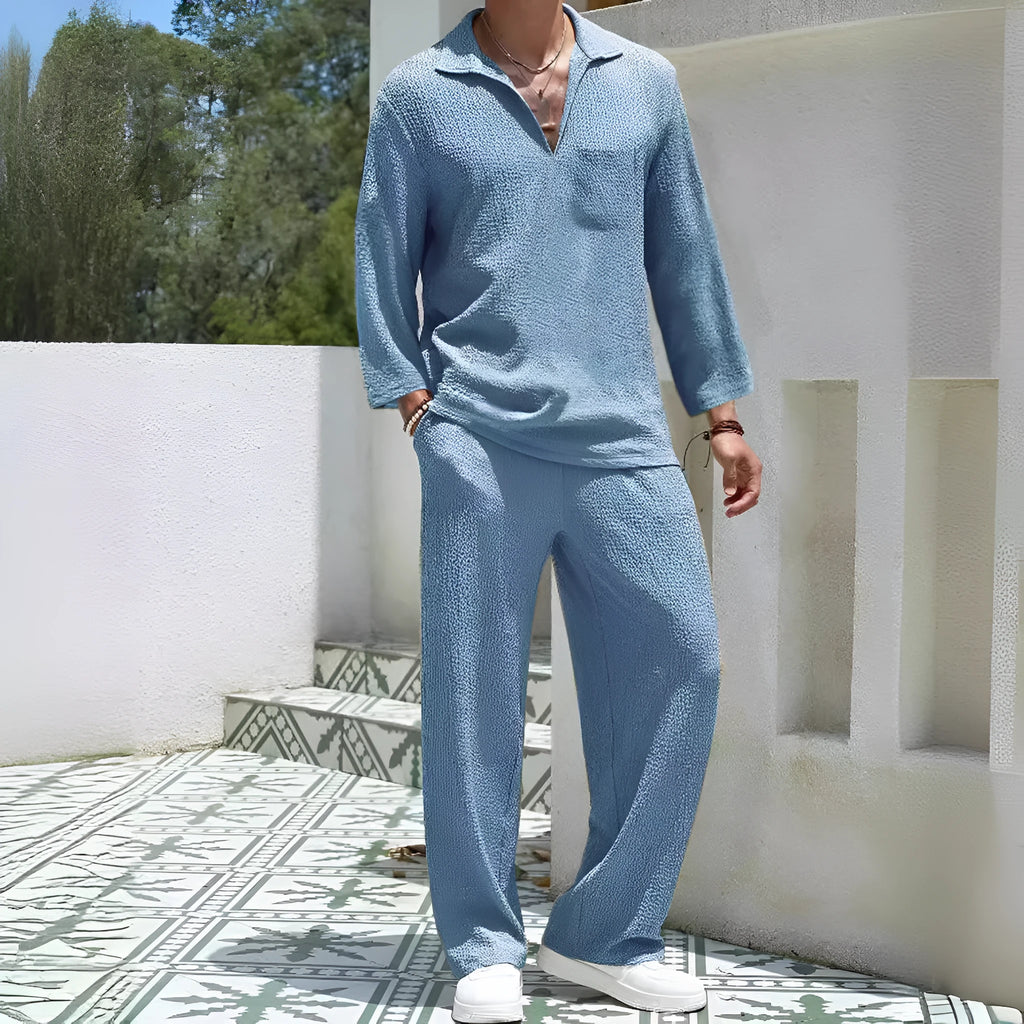 Man wearing a lake blue casual shirt and matching trousers from a polyester suit set.