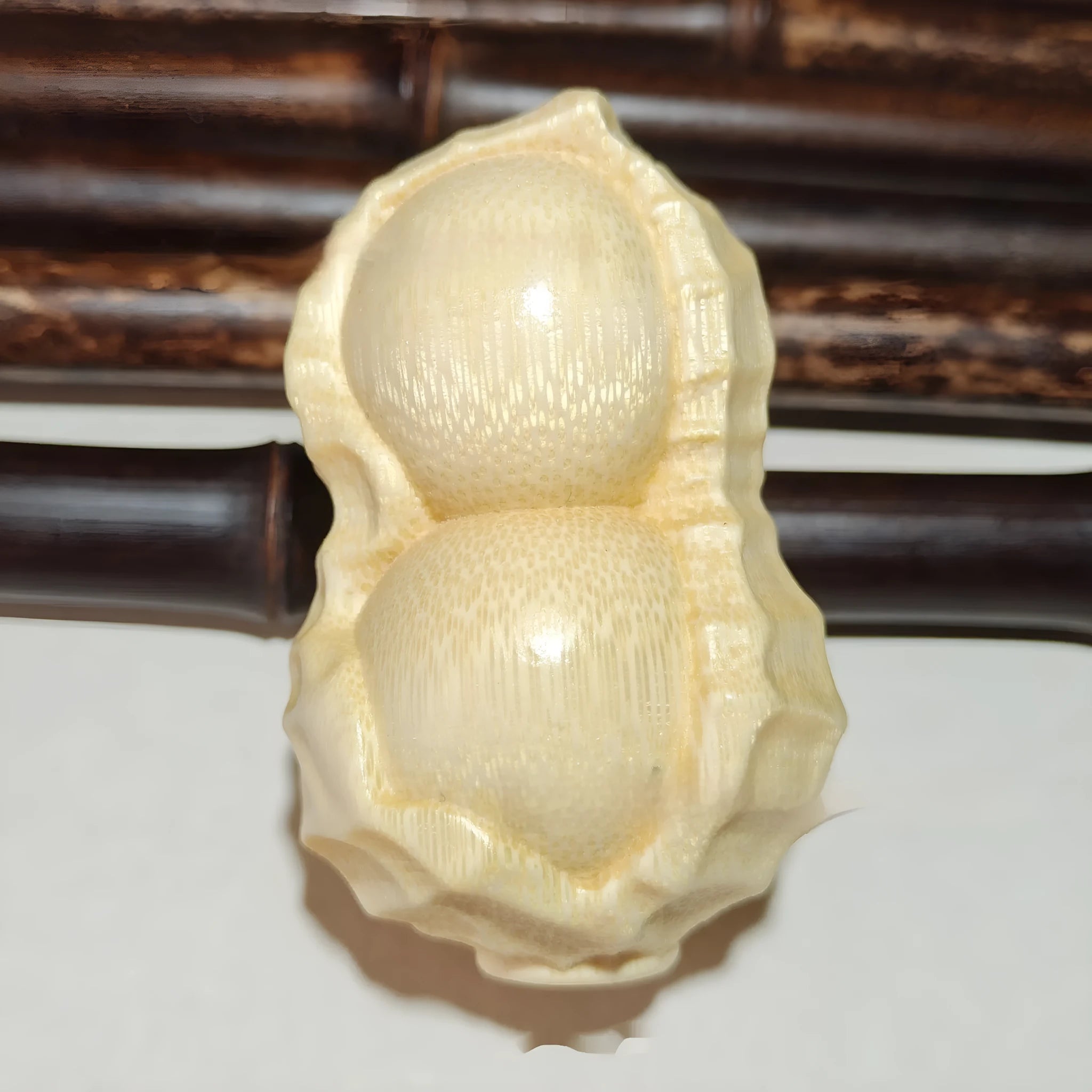 Natural bamboo carving peanut ornament with modern minimalist design and meaningful size detail