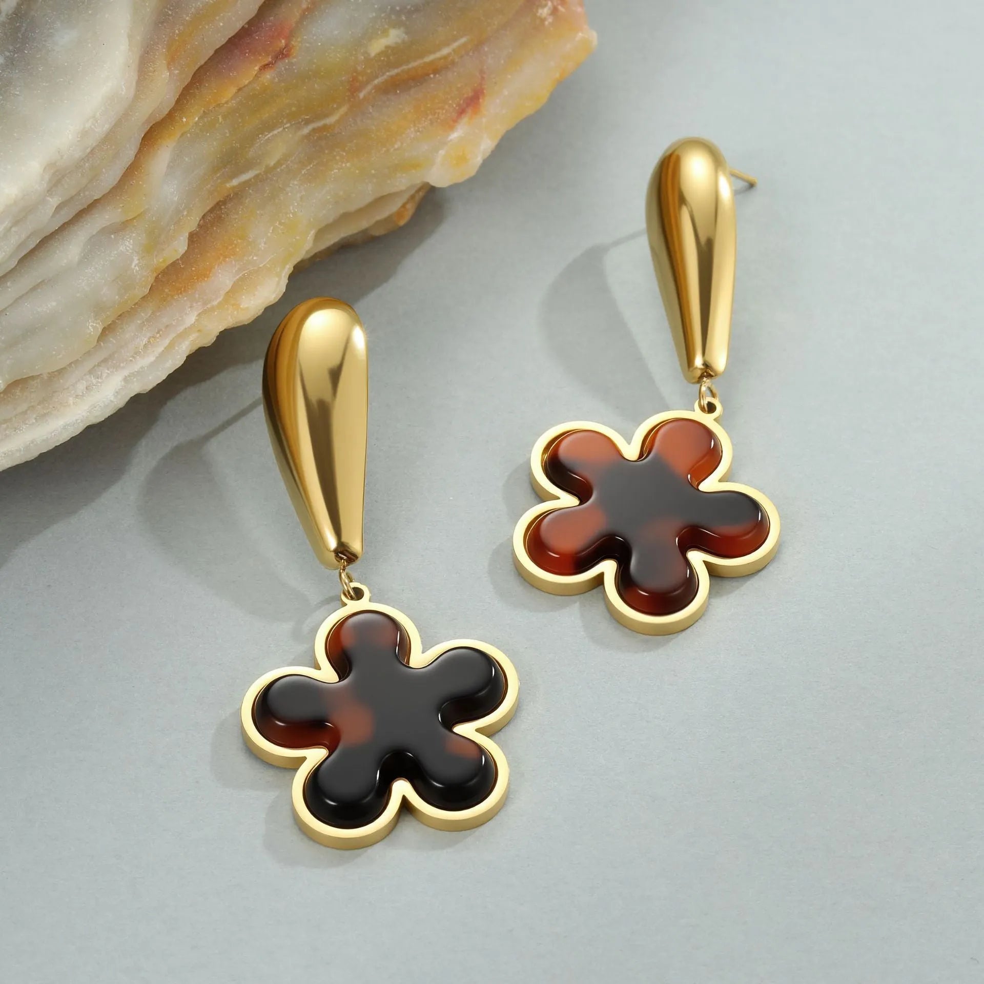 Tortoiseshell resin hawksbill colour earrings with 18K gold electroplating, showing heart-shaped and flower geometric designs