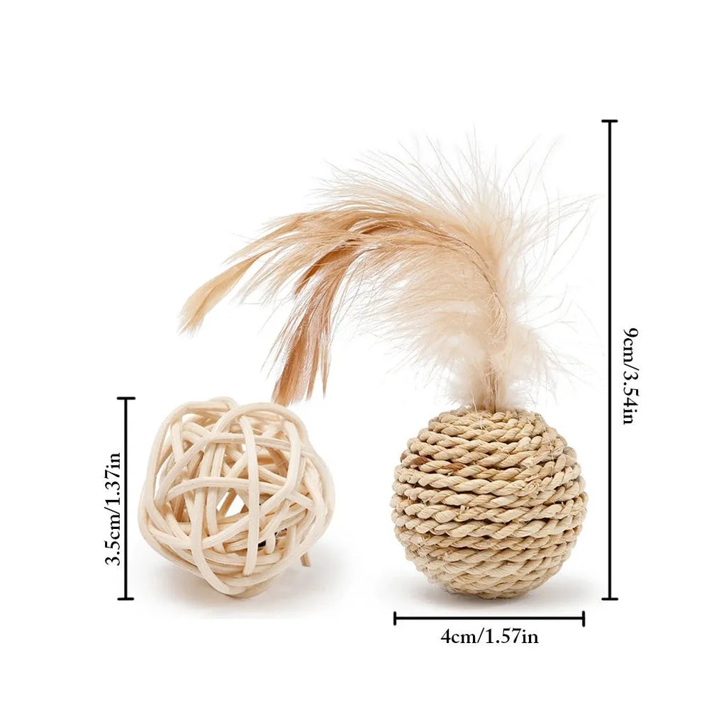 Two cat toys: a natural rattan ball with a bell and a colourful faux feather ball on a plain surface.