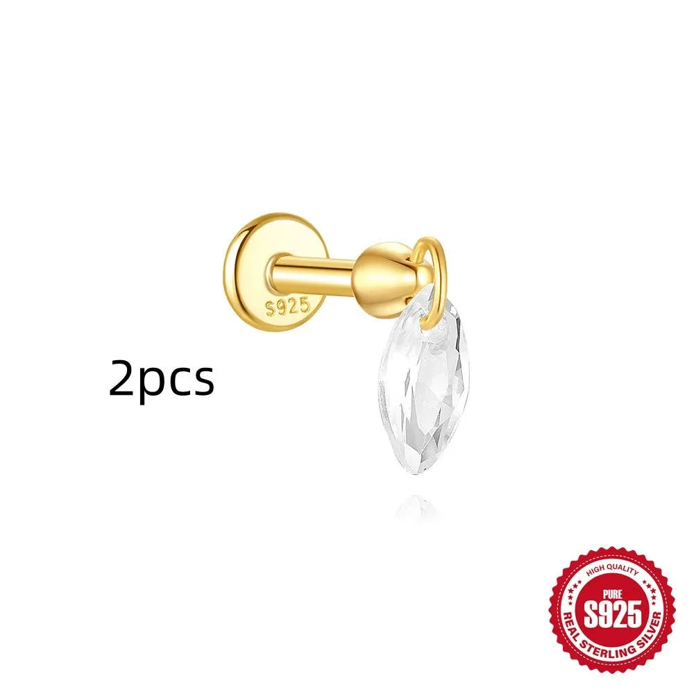 Geometric kite-shaped sterling silver earring with rhinestone head and gold chain tassel.