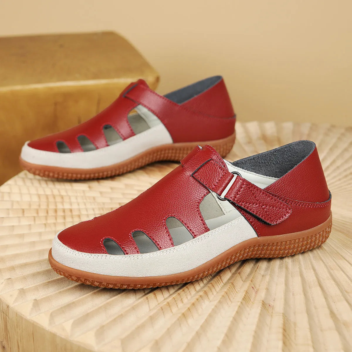 Women's plus size flat sandals with hollow-out toe cap in red, white, or blue on a thick rubber sole.