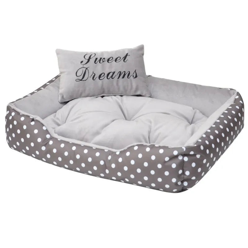 Polka dot printed square dog bed with raised bolsters and a matching embroidered pillow.