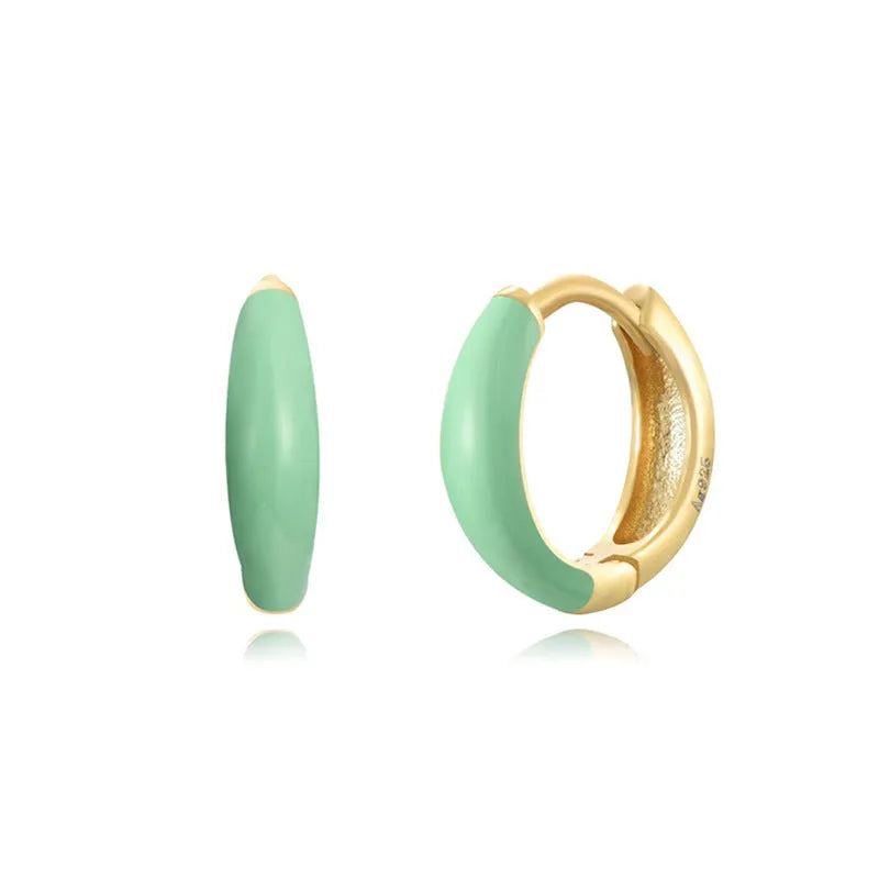 Geometric epoxy resin earrings with dripping oil colour technique showing oval curves and integrated rings