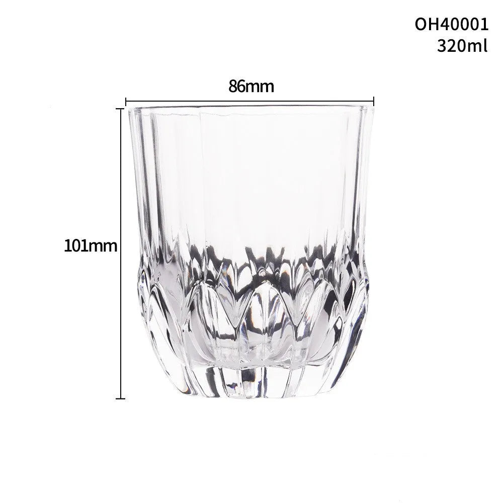 Clear thick-bottom whiskey shot glass with 301-400ml capacity on a table.