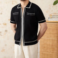 Slim fit black polo shirt with short sleeves and a lapel collar on a mannequin.