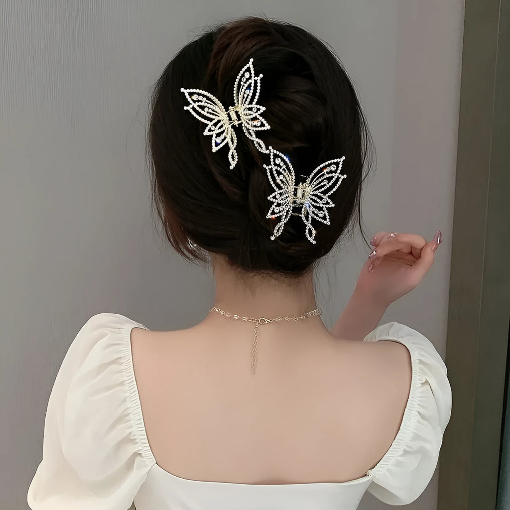 Butterfly-shaped alloy hair clip for women, shown in rhinestone and pearl style options