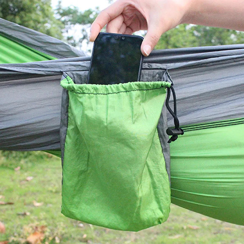 Blue nylon parachute cloth outdoor camping hammock shown in a natural setting.