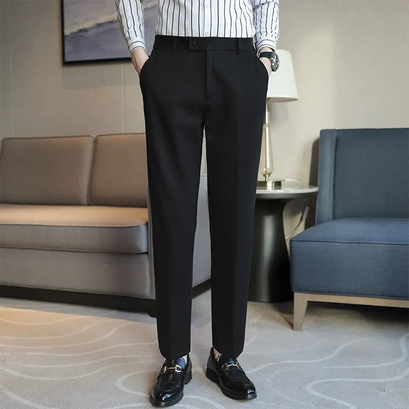 Men's straight leg brown corduroy trousers with an elasticated waistband on a hanger