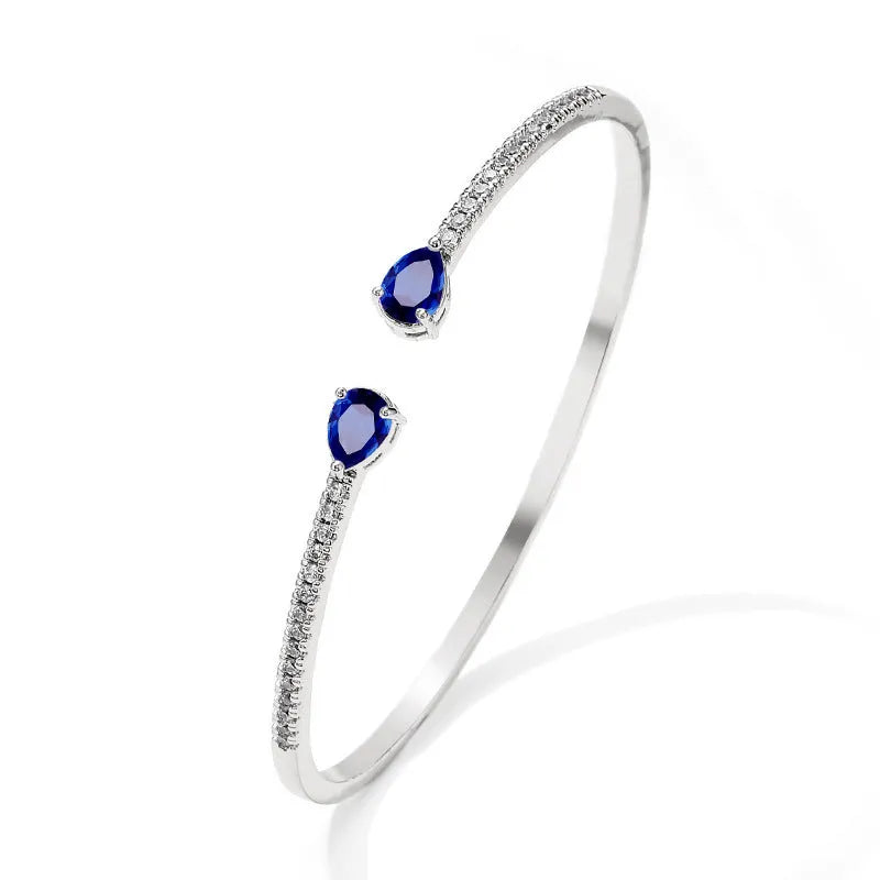 Personalised multi-zircon bracelet in copper, showing detailed inlaid stonework in a simple band style.