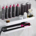 Aluminium punch-free bathroom storage rack holding hair curlers in black finish