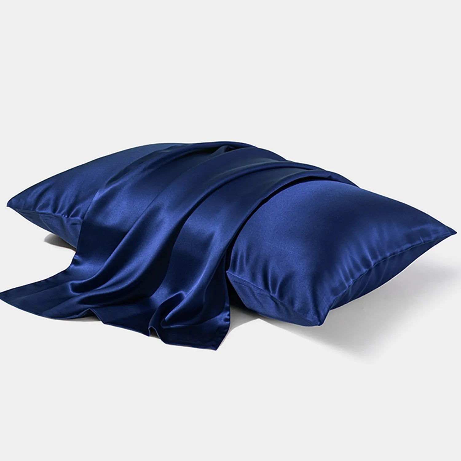 Dark grey silk pillowcase with envelope closure on a bed