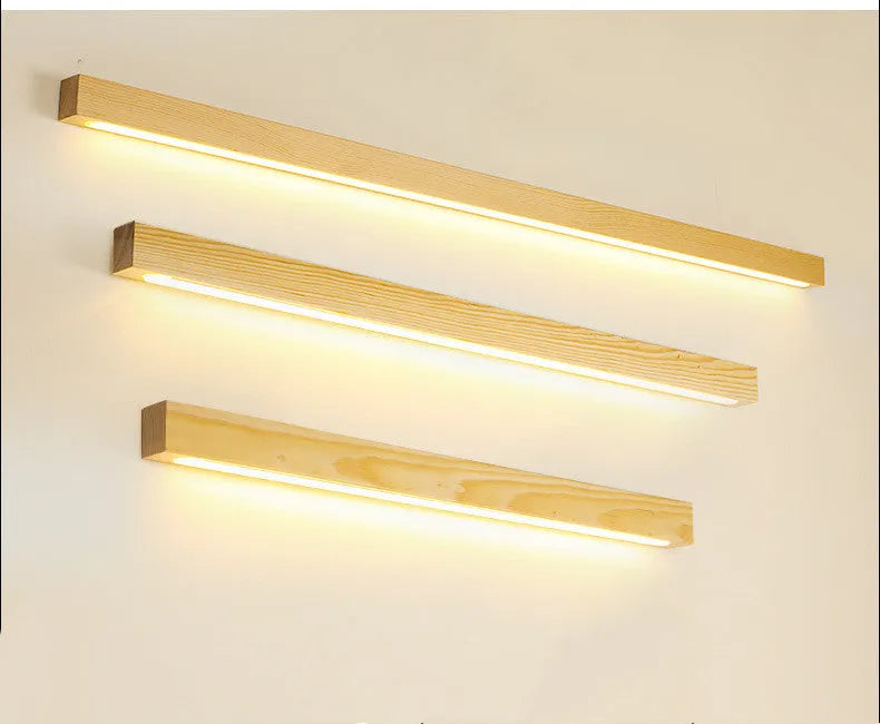 Walnut coloured linear wood and acrylic LED strip wall lamp mounted on a wall.