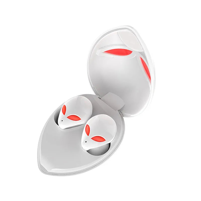 Creative Outer T8 Starman alien-design Bluetooth earbuds with red lighting next to wireless charging case.