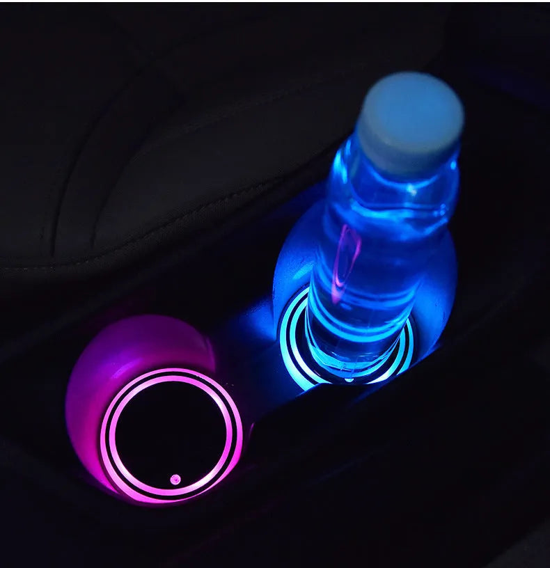 Colourful LED light-up coaster for car cup holder showing seven light colours and USB cable.