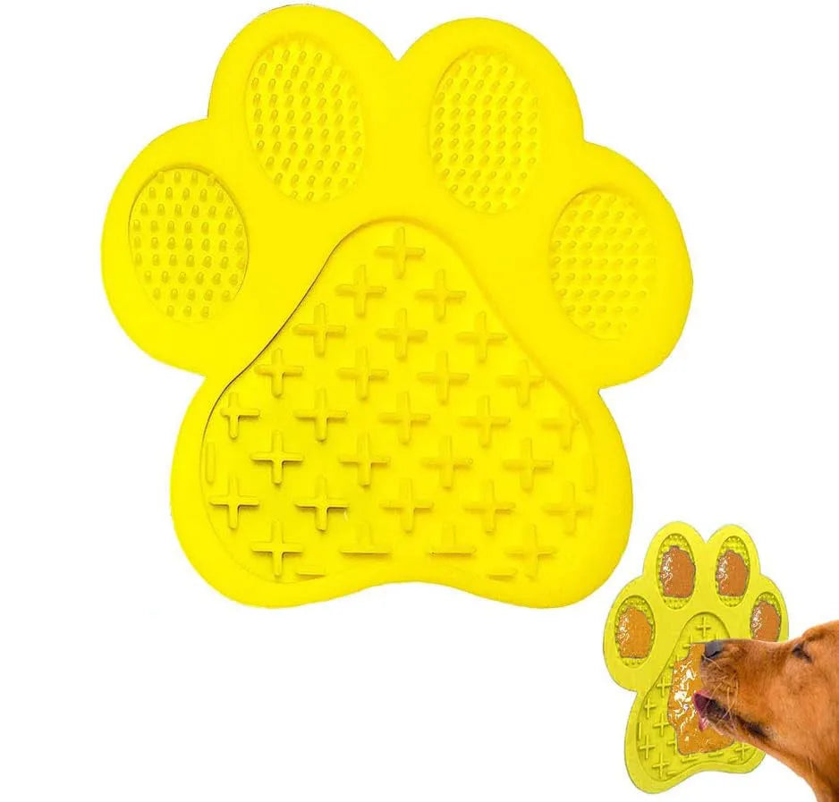 Blue silicone dog licking mat with bone-shape texture and suction cups on a tiled wall.