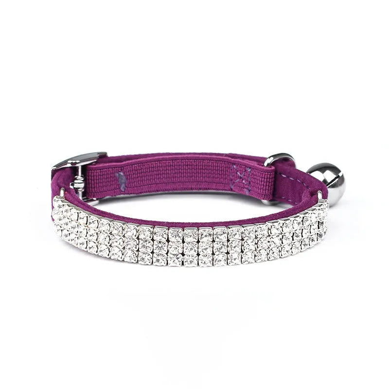 Velvet suede cat collar with rhinestone decoration in various colours on a white background.