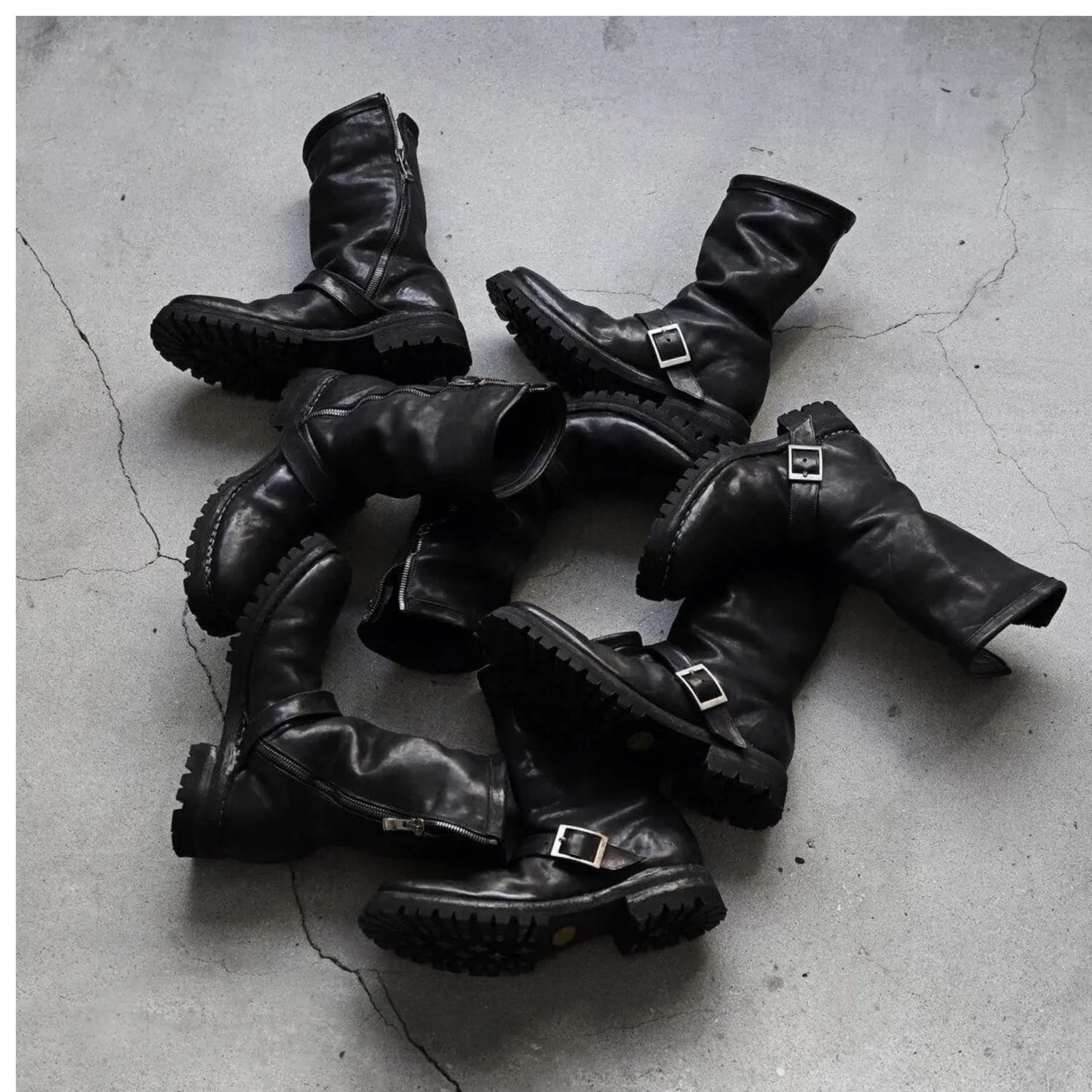 Men's dark retro Martin ankle boots with side zipper on a solid background.